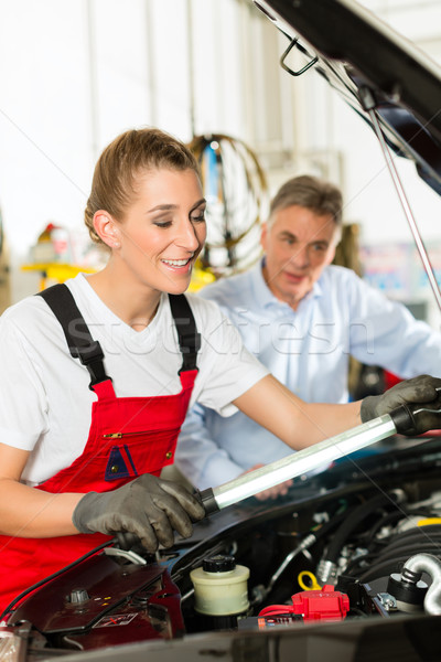 Mature man and female car mechanic in workshop Stock photo © Kzenon