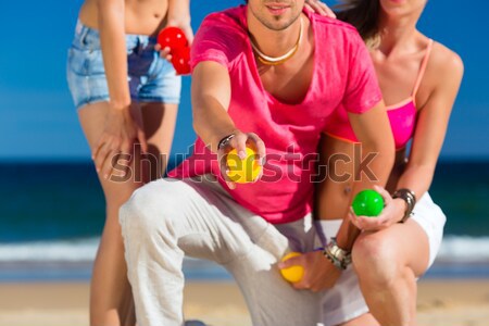 Man and women playing boule on beach Stock photo © Kzenon