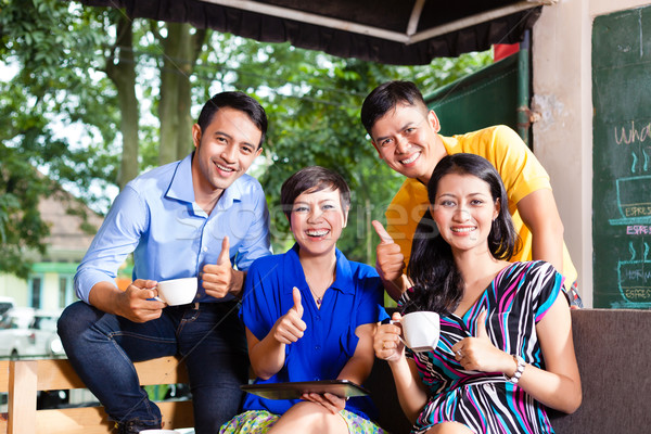 Stock photo: Group of young people in an Asian coffee shop