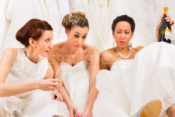 Brides drinking too much in wedding shop or store Stock photo © Kzenon