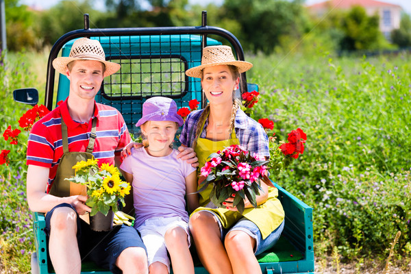 Family on light truck with flowers in garden Stock photo © Kzenon