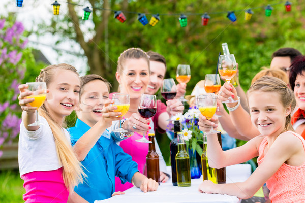 Friends and neighbors toasting on garden party Stock photo © Kzenon