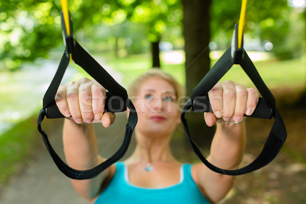 woman doing suspension sling trainer sport Stock photo © Kzenon