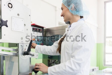 Lab technician storing blood samples in fridge Stock photo © Kzenon