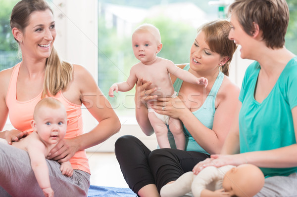 Moms and their babies practicing diaper change Stock photo © Kzenon