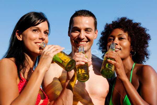 Group of friends drinking beer in swimwear Stock photo © Kzenon