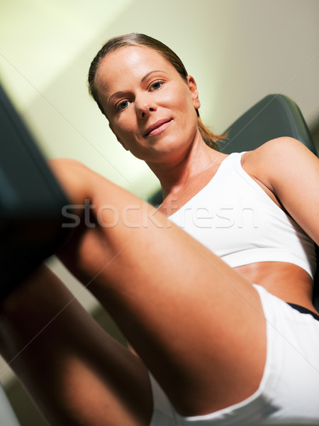 Woman in gym on machine Stock photo © Kzenon