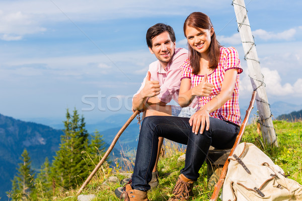 Alps - Hiking Couple takes break in mountains Stock photo © Kzenon