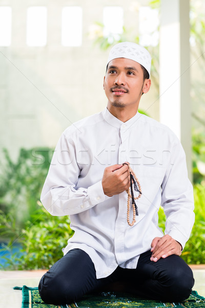 Asian Muslim man praying at home  Stock photo © Kzenon