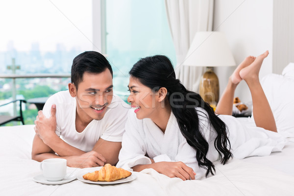 Asian couple déjeuner lit croissant café [[stock_photo]] © Kzenon