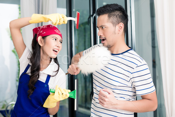 Asian woman and man having fun cleaning home Stock photo © Kzenon