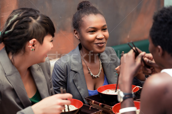 Friends eating noodle soup in Japanese Restaurant Stock photo © Kzenon