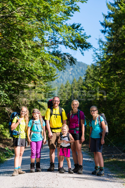 Family with four kids hiking in the mountains Stock photo © Kzenon