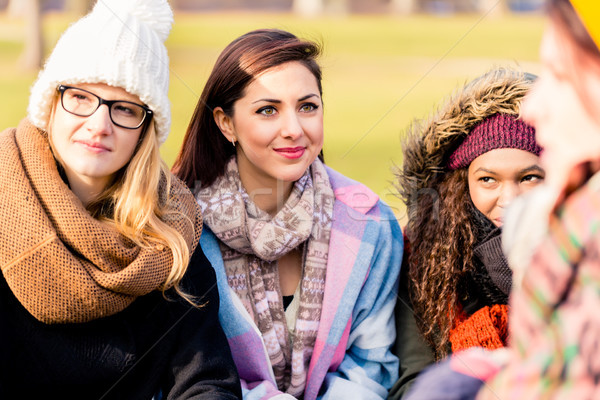 Young women daydreaming while sharing ideas outdoors Stock photo © Kzenon