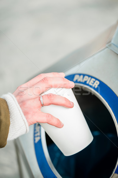 Woman using waste separation container throwing away coffee cup Stock photo © Kzenon