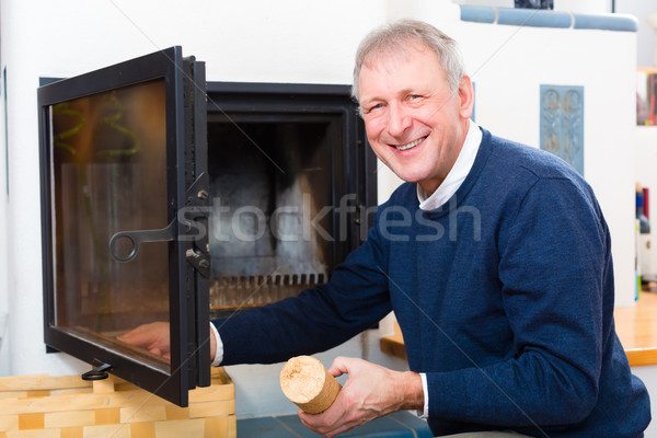 Senior at home in front of fireplace Stock photo © Kzenon