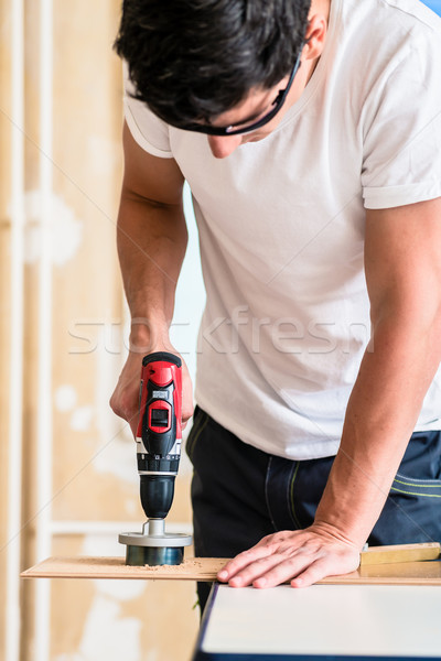Craftsman or DIY man working with power drill Stock photo © Kzenon