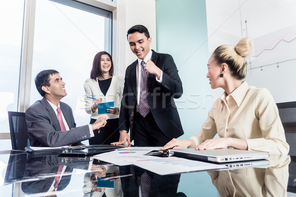 Group of businesswomen and businessmen negotiate contract Stock photo © Kzenon