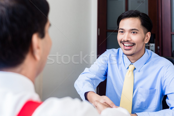 Subordinate professional talks to supervisor in office building Stock photo © Kzenon