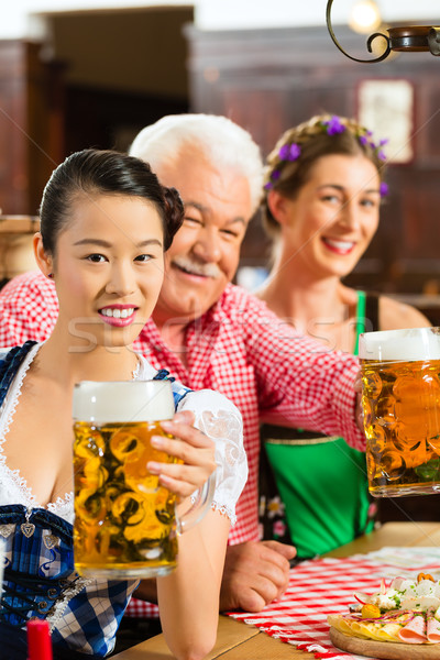friends drinking beer in Bavarian pub Stock photo © Kzenon