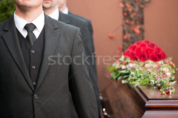 Stock photo: coffin bearer carrying casket at funeral