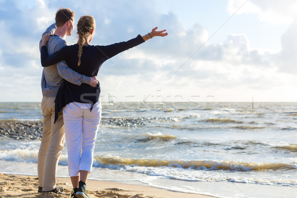 Couple in romantic sunset on ocean beach Stock photo © Kzenon