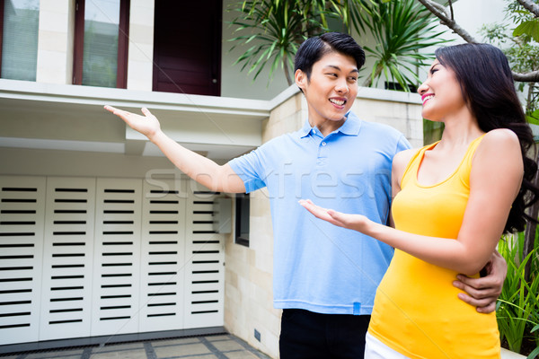 Man shows his woman their new Asian house Stock photo © Kzenon