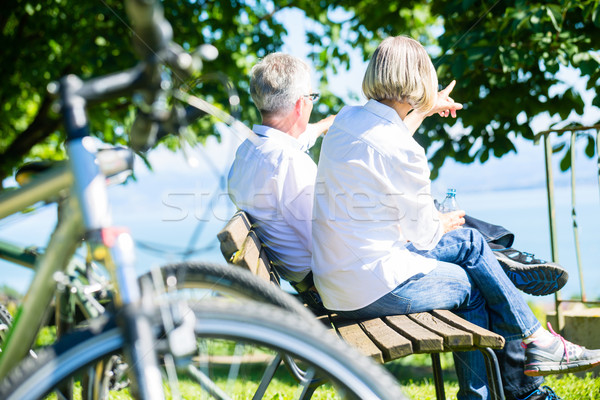 Senior woman and man at rest on bike trip Stock photo © Kzenon