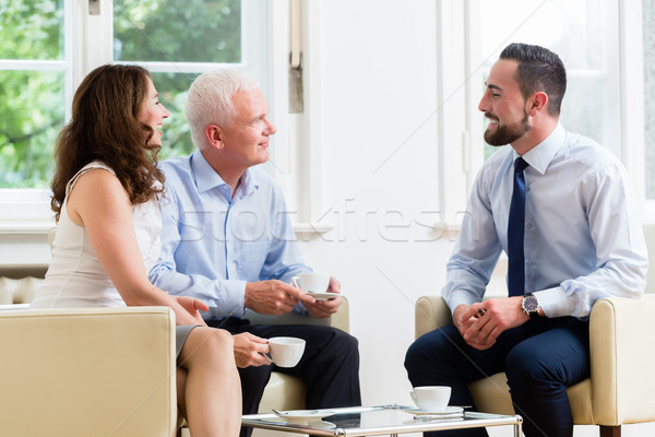 Financial advisor consulting couple in retirement planning Stock photo © Kzenon