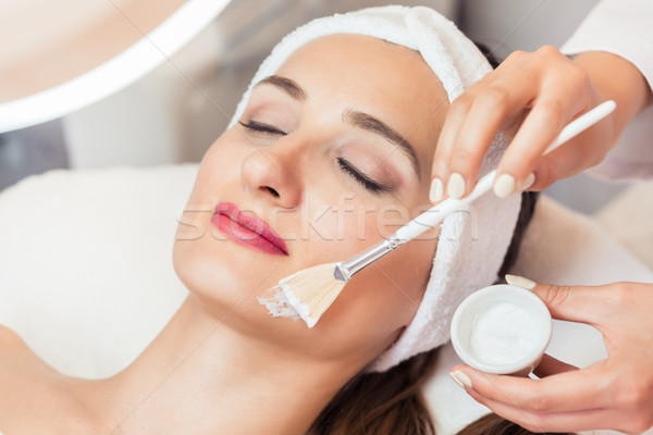 Close-up of a beautiful woman relaxing during facial treatment i Stock photo © Kzenon