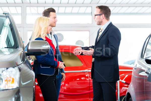 Couple buying new car at auto dealership Stock photo © Kzenon