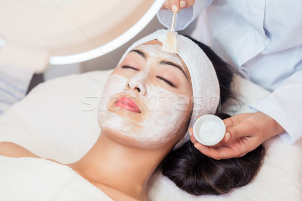 Stock photo: Young woman relaxing under the gentle touch of the specialist