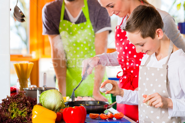 Family cooking healthy food in domestic kitchen  Stock photo © Kzenon