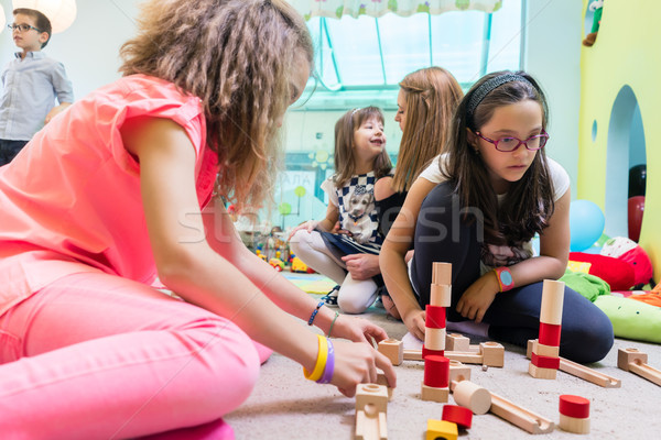 Cute girl building a structure in balance during playtime at the Stock photo © Kzenon