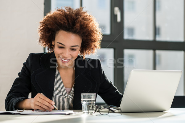 Expert analyzing business report in the office Stock photo © Kzenon