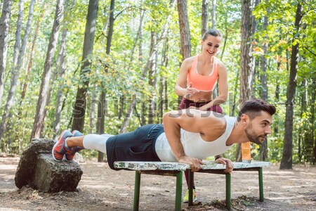 Man and woman warming up and stretching before exercise Stock photo © Kzenon