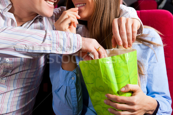 Stock photo: Couple in cinema theater with popcorn