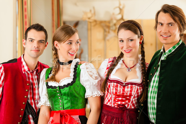 Young people in traditional Bavarian Tracht in restaurant or pub Stock photo © Kzenon