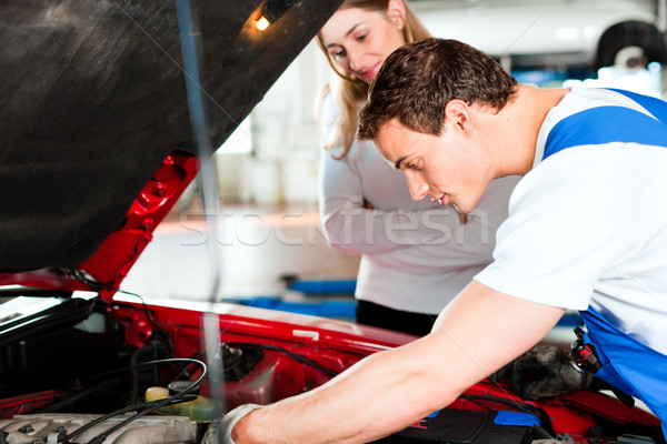 Woman talking to car mechanic in repair shop Stock photo © Kzenon