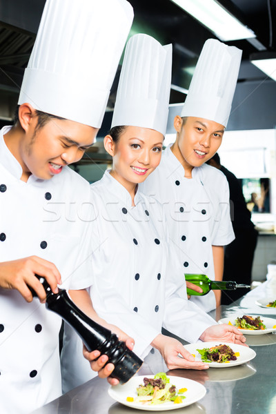 Stock photo: Asian Chef in restaurant kitchen cooking