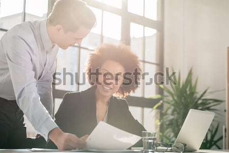 Business man showing to his colleague a document Stock photo © Kzenon
