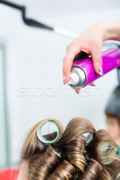 Hairdresser - hair stylist curling hairs Stock photo © Kzenon