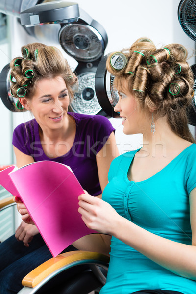 Women at the hairdresser with hair dryer Stock photo © Kzenon