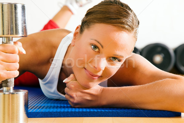 Woman with dumb bell in the gym Stock photo © Kzenon