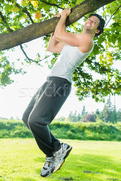 People in city park doing chins or pull ups Stock photo © Kzenon