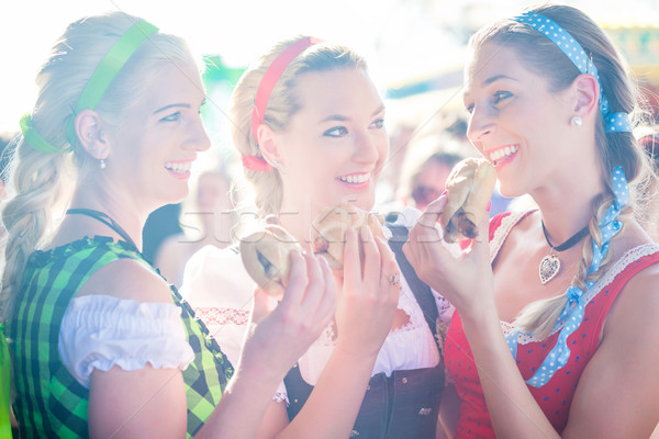 Friends eating grilled sausage at Oktoberfest Stock photo © Kzenon