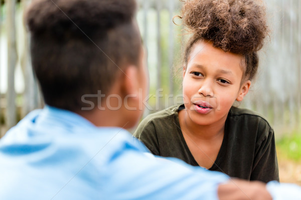 Siblings sitting on floor in yard Stock photo © Kzenon