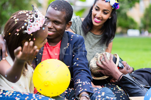 Indian girl and african couple celebrating together on street pa Stock photo © Kzenon