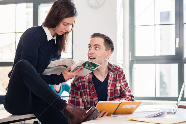 Friendly student helping his classmate by explaining and showing Stock photo © Kzenon