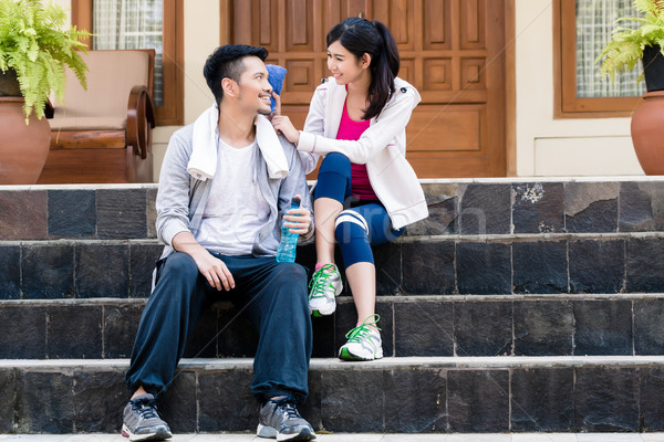 Young woman wiping away the sweat from the face of her boyfriend Stock photo © Kzenon